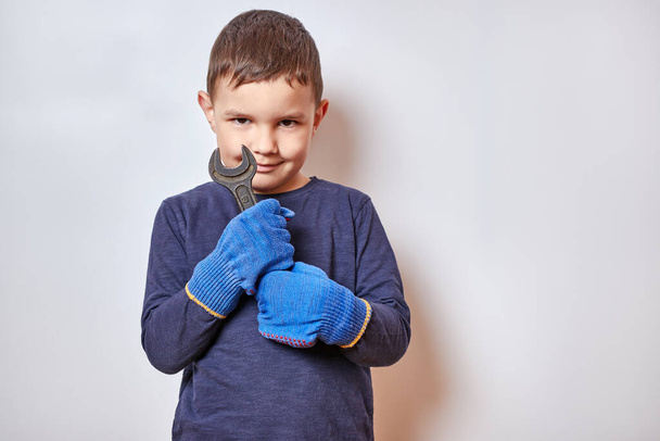 Handsome little boy holding a wrench. - Photo, Image