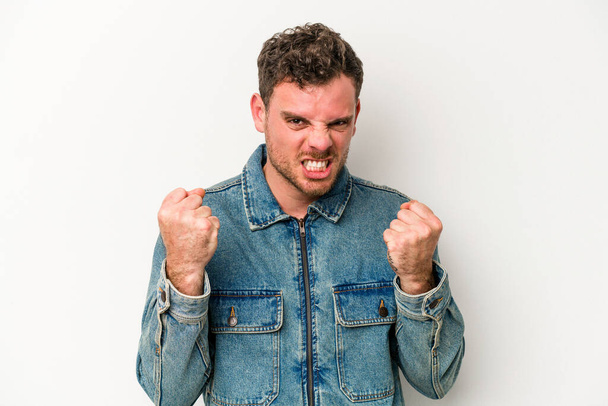 Young caucasian man isolated on white background upset screaming with tense hands. - Фото, зображення