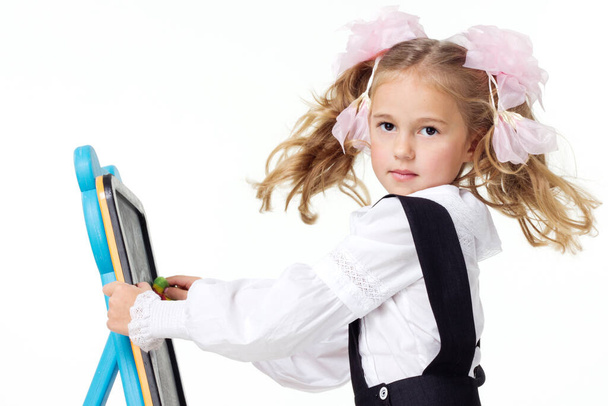 Portrait of a first grader in a school uniform on a white background. - 写真・画像