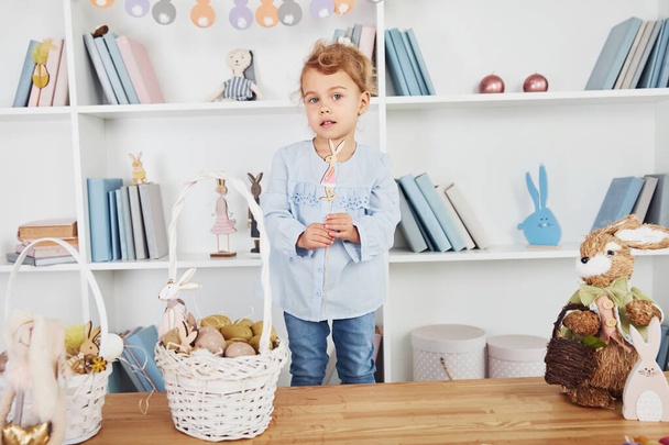 Cute little girl playing with toys when celebrating Easter holidays indoors. - Foto, Imagen