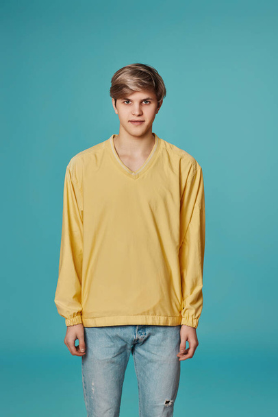 young handsome guy in yellow sweater posing - Foto, Imagen