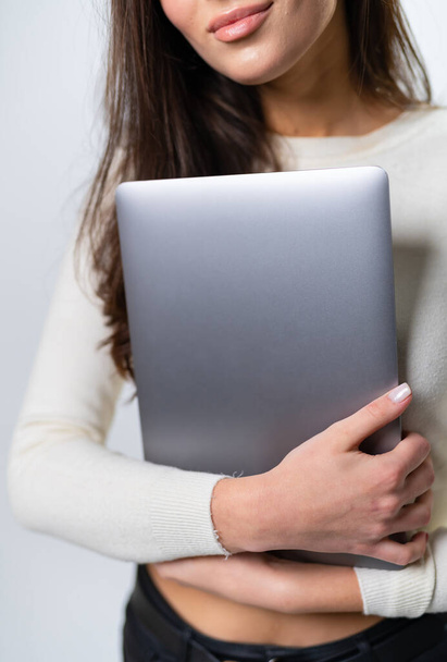 Charming lady with grey laptop in hands. Modern technology notebook with beautiful woman. - Foto, immagini