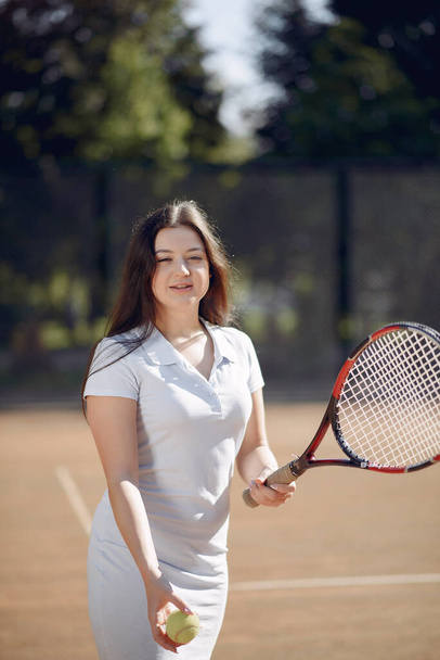 Caucasian female tennis player playing on the court outdoors - Foto, immagini