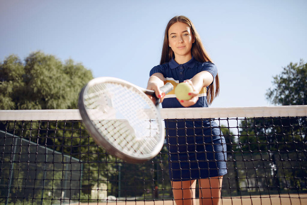 Caucasian female tennis player holding a racket and posing for a photo - Фото, изображение