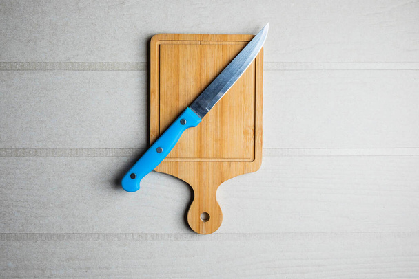 Cutting board and a knife on the table - Fotografie, Obrázek