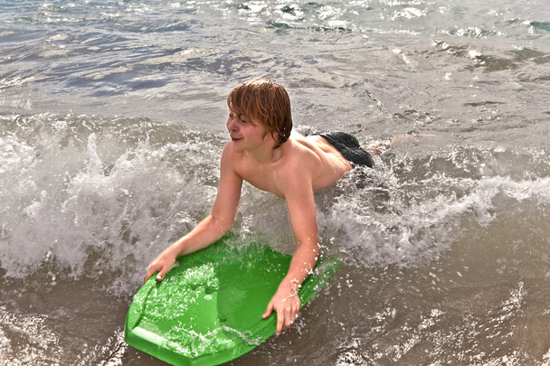 Boy has fun at the beach - Photo, image