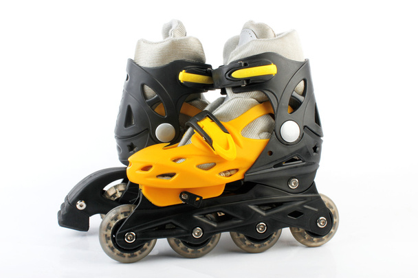 Yellow & Black Colored roller skates isolated on white - 写真・画像