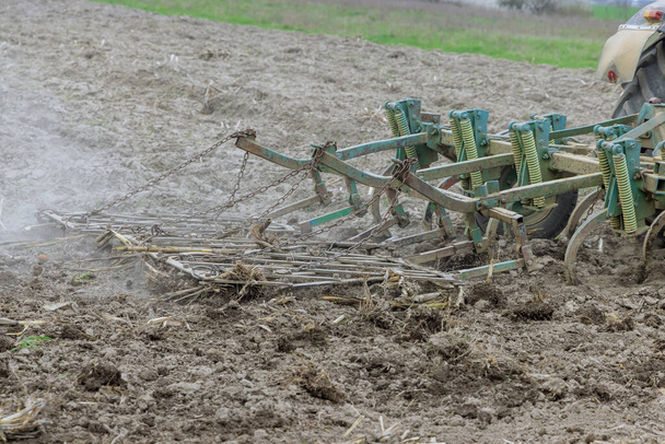 Traktori murskaa maaperän valmis kylvö viljelykasvien. - Valokuva, kuva
