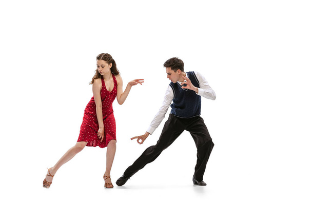 Beautiful girl and stylish man in vintage retro style outfits dancing isolated on white background. Timeless traditions, 60s,70s american fashion style and art - Φωτογραφία, εικόνα