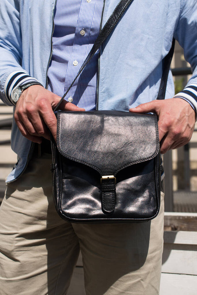 close-up photo of black leather bag in mans hand - Φωτογραφία, εικόνα