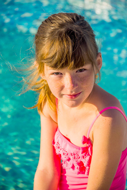 a portrait of a little girl in swimming pool - Photo, Image