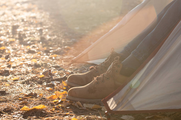 girl hiker in a tent,  boots in the dawn ligh - Foto, Imagem