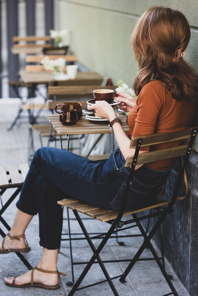 girl drinking coffee on the outdoor terrace in a caf - 写真・画像