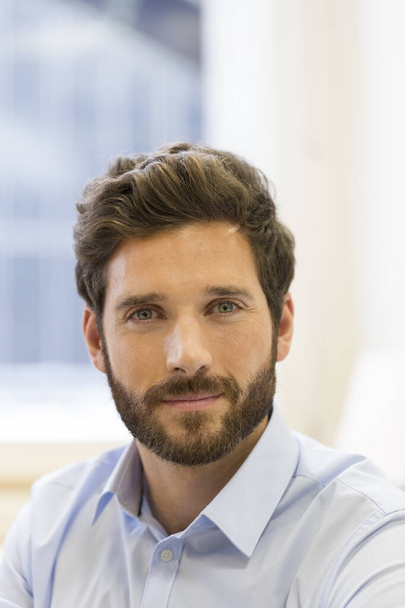 Portrait of handsome bearded man in office. looking camera - Photo, Image
