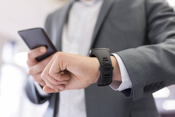 Man with Mobile phone connected to a smart watch - 写真・画像