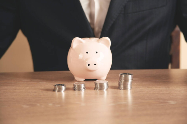 businessman hand holding coins putting in jar concept finance and accounting saving - Φωτογραφία, εικόνα
