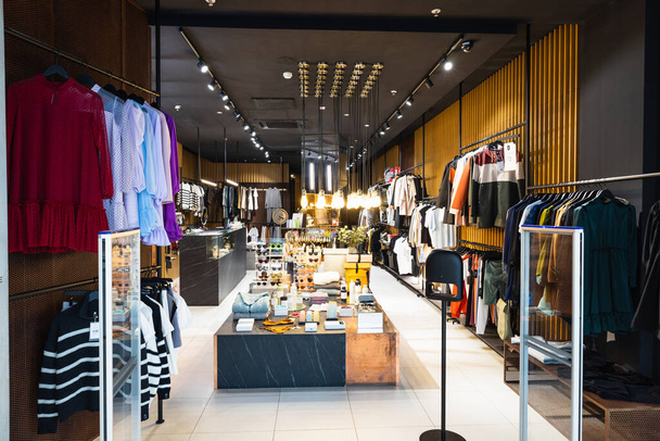 Interior of a brand new fashion clothing store. Panorama, Vilnius, Lithuania 10 April 2022 - Фото, изображение