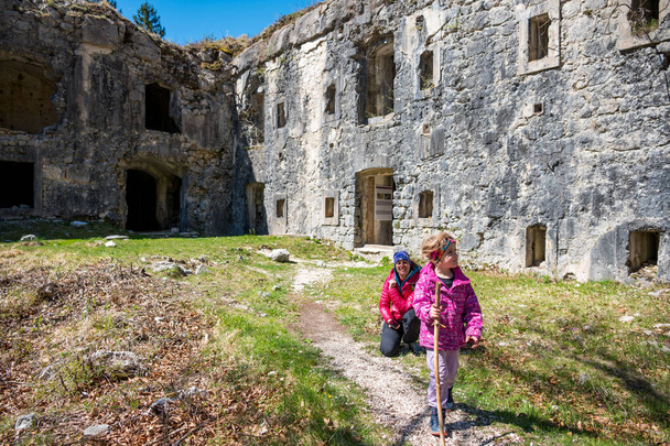 Mother and daughter posing in front of ruins of first world war fortress. Family exploring history. - Photo, Image