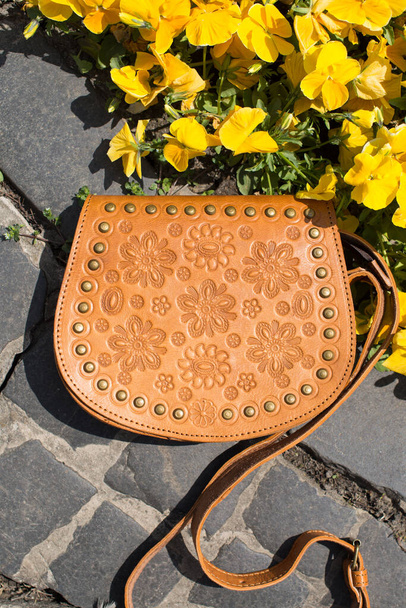 small yellow womens leather bag with a carved pattern - Photo, Image