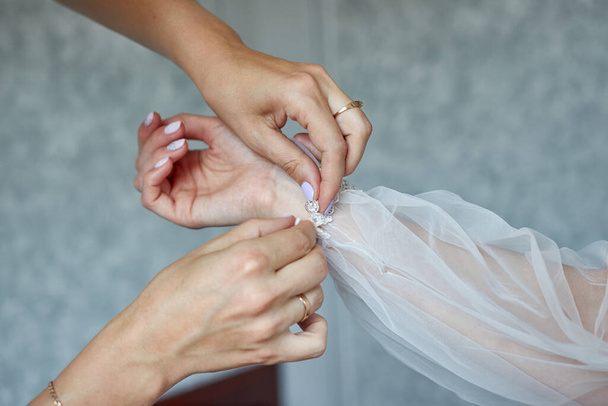 bride hand  in wedding dress. woman helping bride  - Fotografie, Obrázek