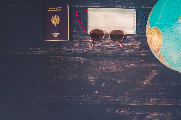 World map and items on wooden background, flat lay. summer travel wanderlust concept, space for text. map camera sunglasses passport phone pen mask book on wooden background top view. planning vacation concept. - Fotoğraf, Görsel