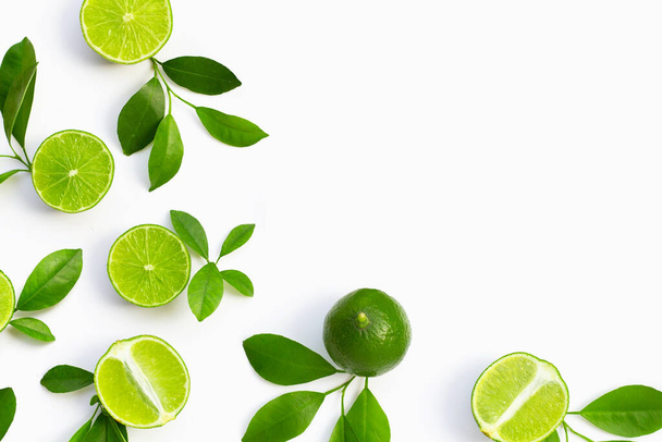 Fresh limes with green leaves on white background. Top view - Foto, Bild