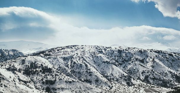 Landscape of  mountains with snow and clouds. - Foto, afbeelding