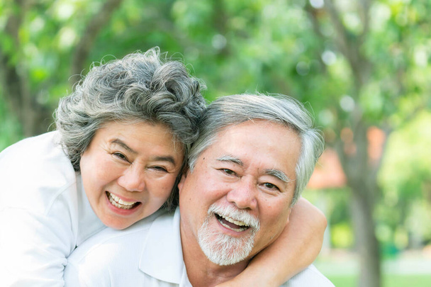 Gelukkig liefde Ouderen paar glimlach gezicht, senior paar oude man en senior vrouw ontspannen knuffel in een bos - Foto, afbeelding