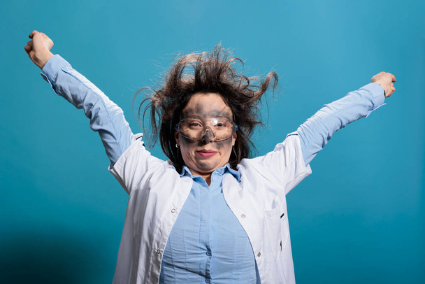 Funny looking scientist with messy hair and dirty face recovering from dangerous chemical explosion - Foto, afbeelding