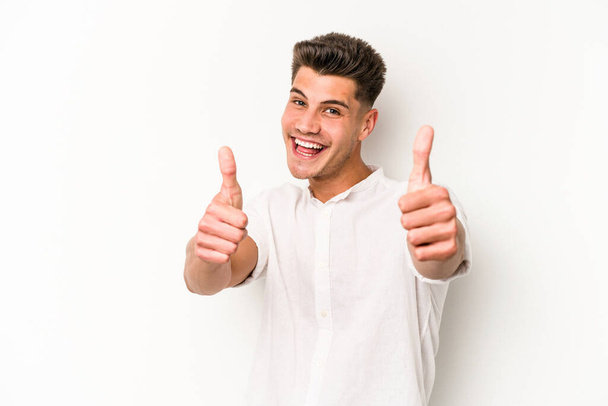 Young caucasian man isolated on white background raising both thumbs up, smiling and confident. - Photo, Image