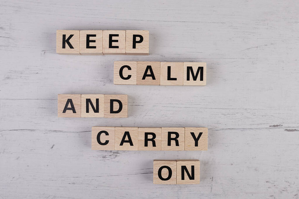 wooden blocks building the word KEEP CALM AND CARRY ON - Foto, imagen