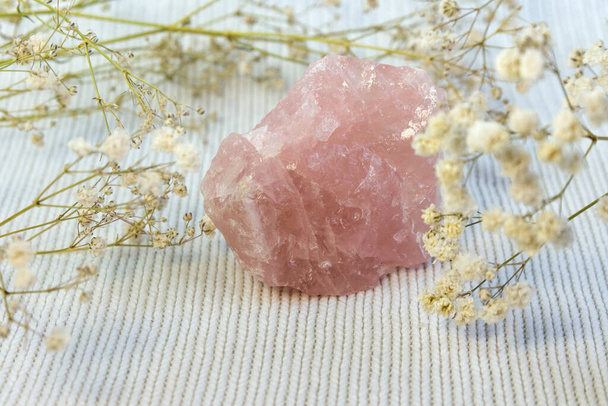 Piece of unpolished rough pink quartz as nice background. Minimal color still life photography - Фото, изображение