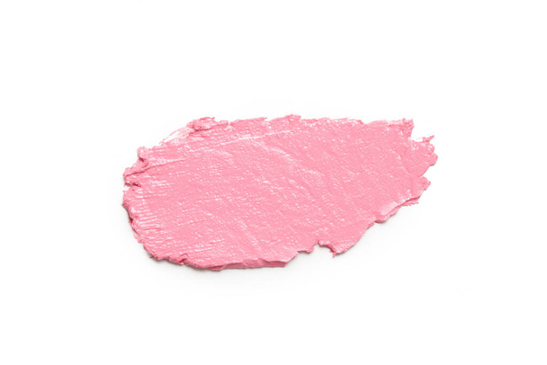 Pinkfarbenes Schminkmuster auf weißem Hintergrund. Dekorative kosmetische Schmierereien. - Foto, Bild