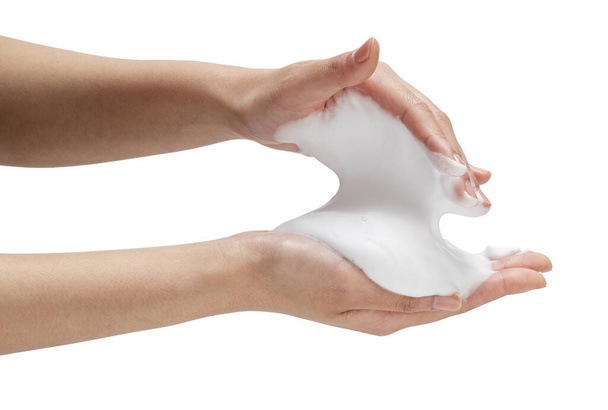 Female hand with soap bubbles on white background. Hands with white bubbles. Texture of white soap foam on female hand. - Fotó, kép