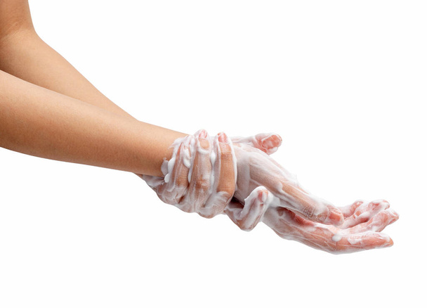 Female hand washing hands with soap lather on white background. Hands with white foam. Texture of white soap foam on female hand. - Valokuva, kuva