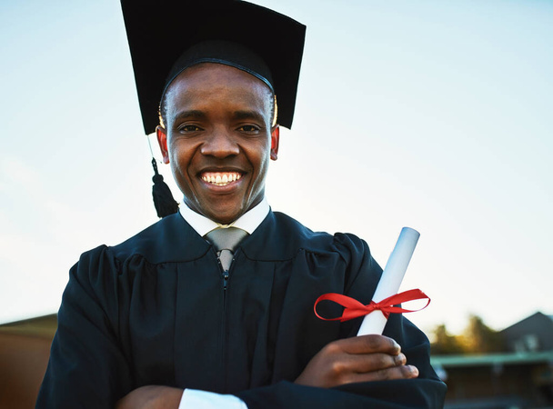 If you believe you can, you can. Portrait of a confident young man holding a diploma on graduation day. - Photo, Image