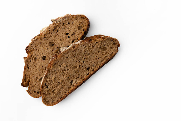 two slices of rye bread on white background, top view, fresh delicious homemade healthy baking - Fotografie, Obrázek