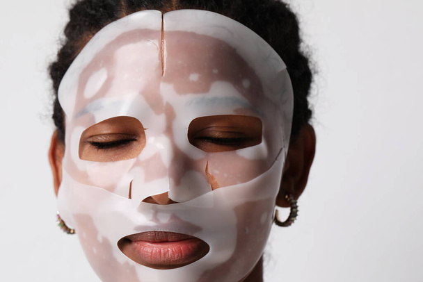 Mock-up of woman applies a hydro gel face mask. Skin care and beauty treatments - Valokuva, kuva