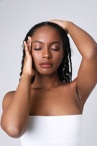 Vertical close-up of African American young woman poses indoor. Isolated. - Photo, image