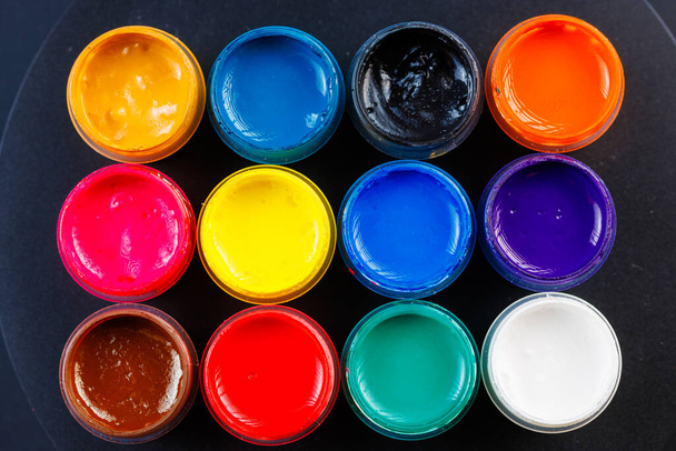 full-frame close-up background of opened small gouache paint jars - Photo, Image