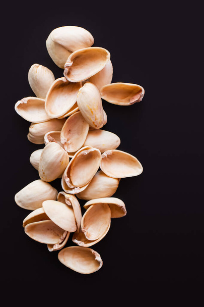 top view of nutshells from pistachios isolated on black  - Fotoğraf, Görsel