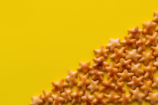 flay lay view of tasty cookies in shape of stars on yellow - Photo, Image