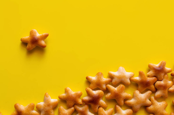 top view of tasty cookies in shape of stars on yellow - Fotoğraf, Görsel