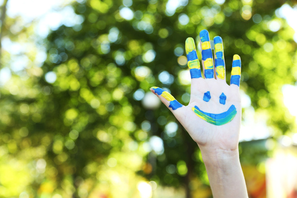 Smiling colorful hand on natural background - Fotoğraf, Görsel