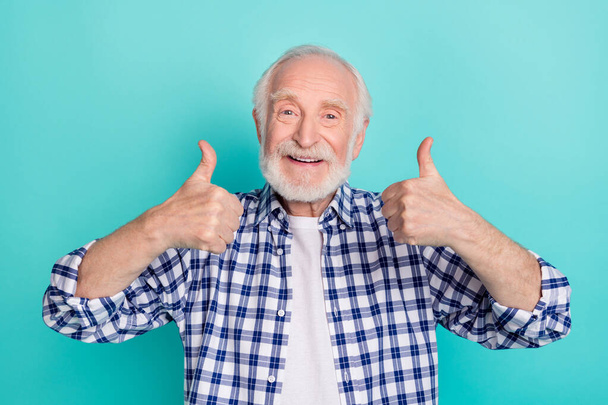 Photo of handsome cute grandfather showing thumb-up give you recommendation isolated on turquoise color background - 写真・画像
