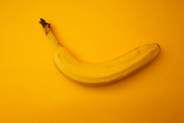 Yellow banana lies on a bright background - Foto, immagini