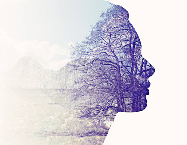 We are all part of nature. Composite image of nature superimposed on a womans profile. - Photo, image