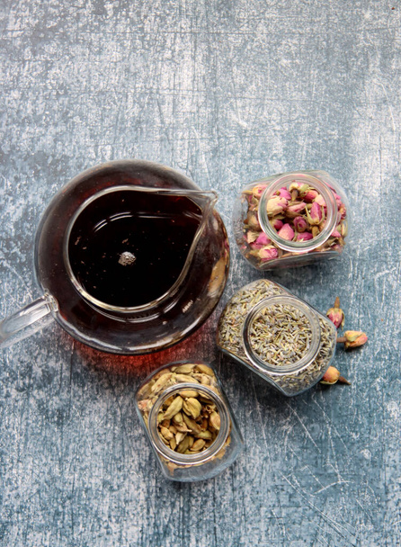 Different tea flavors top view photo. Cinnamon, anise, cardamom, clove, lavender, roses on a table. Aromatic tea close up. Natural antioxidant concept.  - Fotoğraf, Görsel