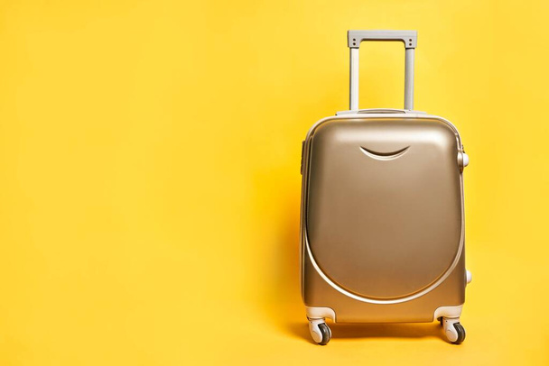 Travel suitcase on bright yellow background - Zdjęcie, obraz