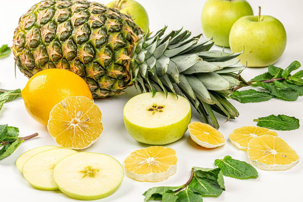 Close-up, pineapple with lemon, apple and mint leaves - 写真・画像